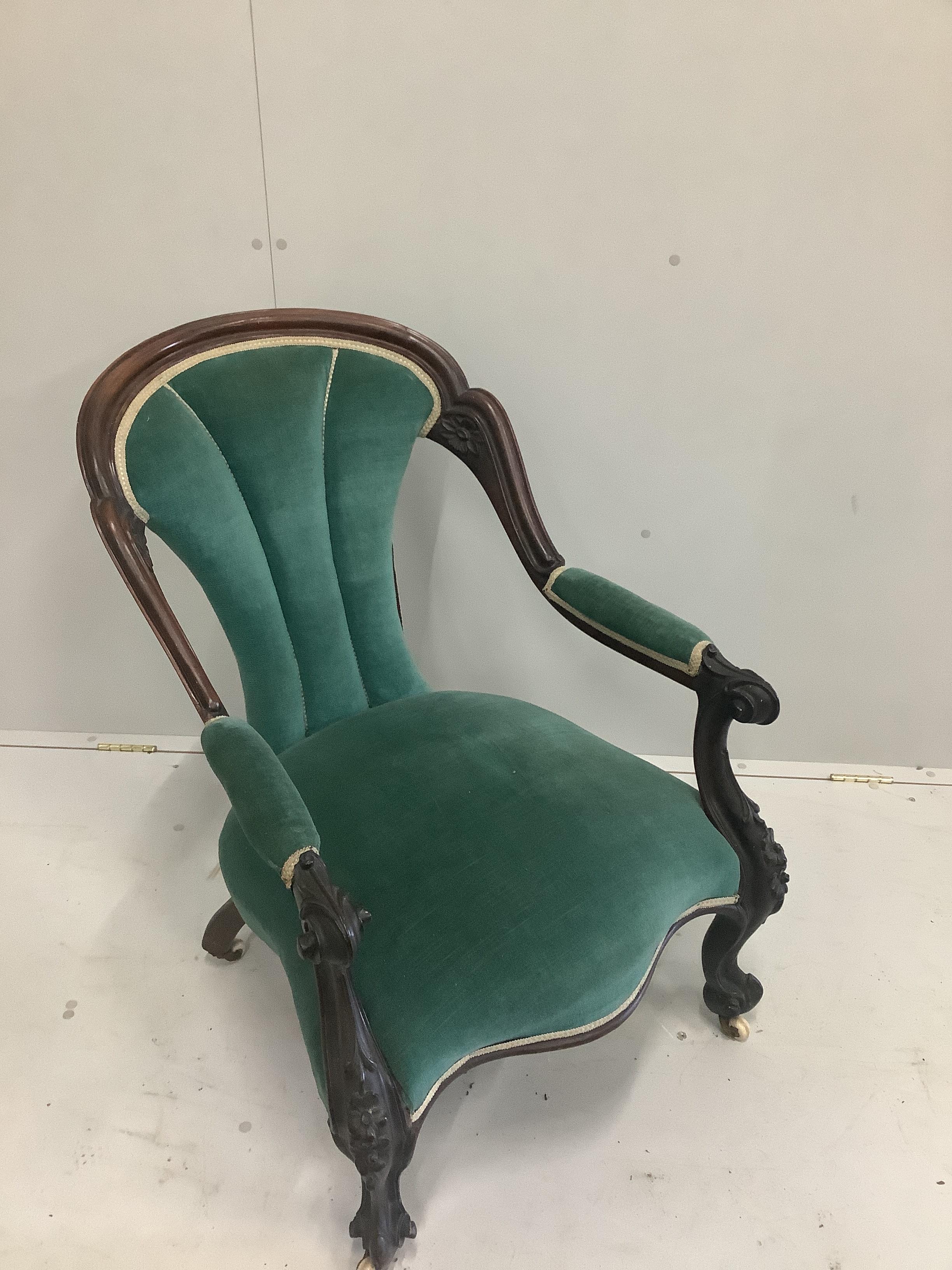 A Victorian carved mahogany open frame armchair